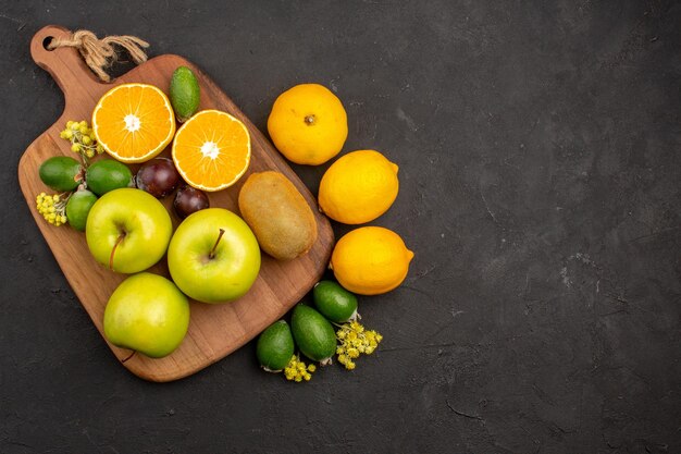 Top view different fruits composition ripe and mellow fruits on dark background fruit ripe tree fresh mellow