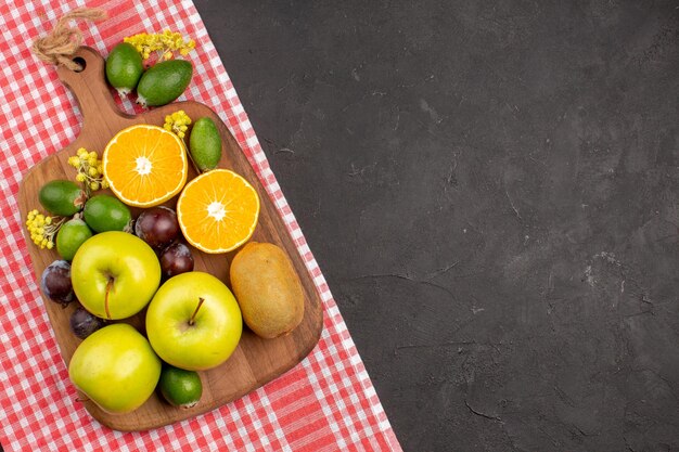 Top view different fruits composition ripe and mellow fruits on a dark background fruit ripe tree mellow