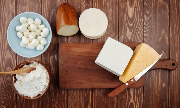 Top view of different kind of cheese on rustic wooden table