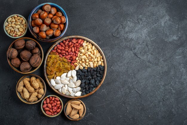 Top view different nuts with raisins and dried fruits on grey background nut snack raisin dry fruit nuts