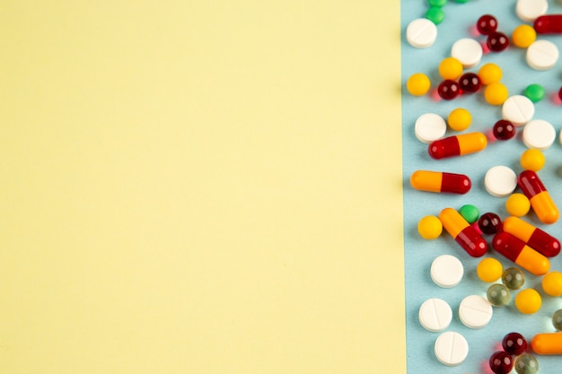 Vista dall'alto diverse pillole su sfondo colorato