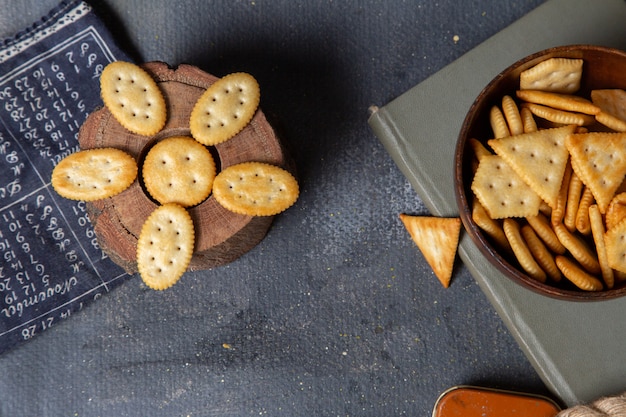 Top view different salted crackers on the grey background crisp snack photo cracker