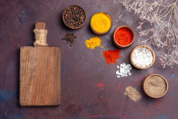 Top view different seasonings inside pots on a dark background soup sauce meal spicy pepper food