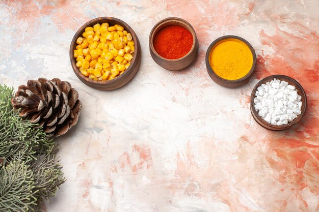 Top view different seasonings with corn on light background