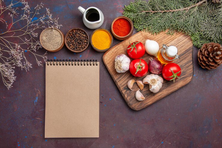 Free Photo top view of different seasonings with fresh vegetables on black