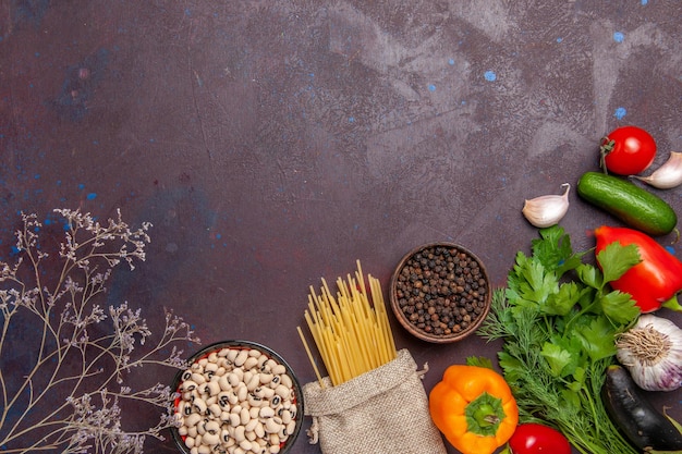 Top view different seasonings with fresh vegetables on the dark background salad vegetable product food meal