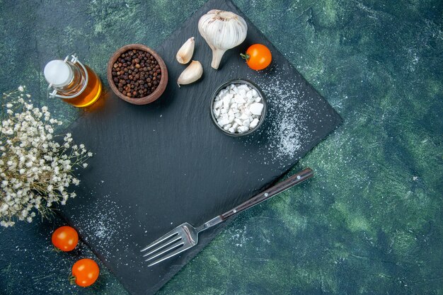 top view different seasonings with garlic and oil on dark background