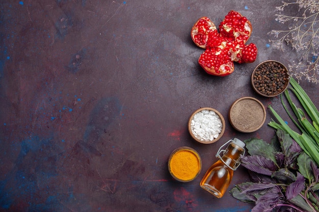 Top view different seasonings with oil on dark surface pepper spicy hot fruit