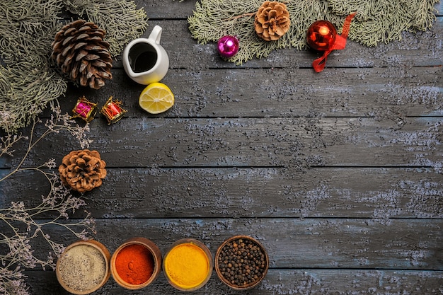 Free photo top view different seasonings with tree on dark desk