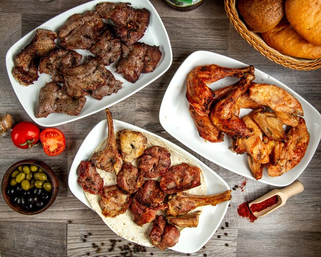 Top view of different types of kebabas beef  chicken and lamb ribs on a wooden table