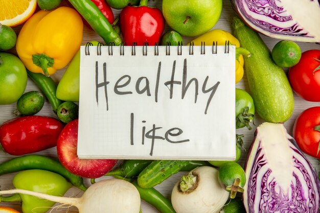 Top view different vegetables with fruits on white background diet salad health ripe color