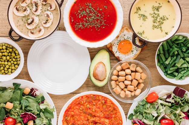 Top view of dishes with avocado and salads