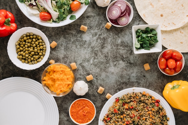 Top view of dishes with bell pepper and cheese