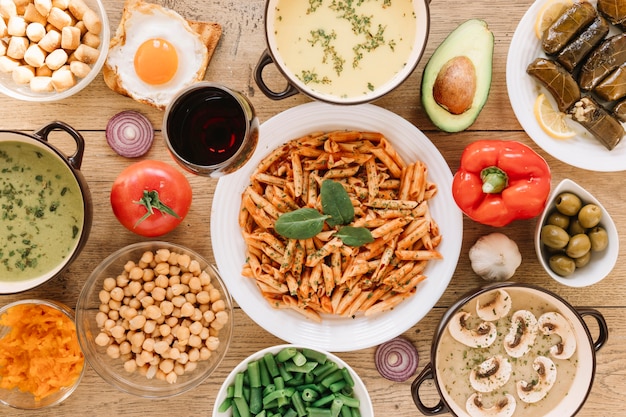 Top view of dishes with glass of wine and olives