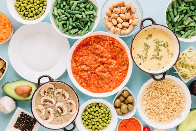 Top view of dishes with green peas and avocado