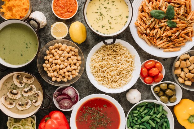 Top view of dishes with noodles and tomato soup