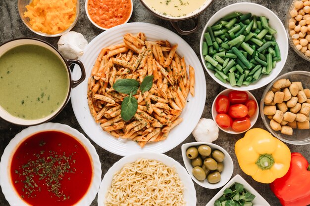 Top view of dishes with pasta and green beans