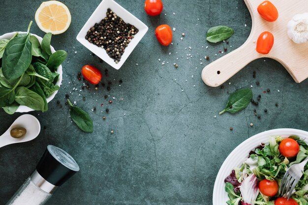 Top view of dishes with pepper and cherry tomatoes with copy space