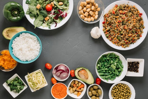 Top view of dishes with rice and avocado and copy space