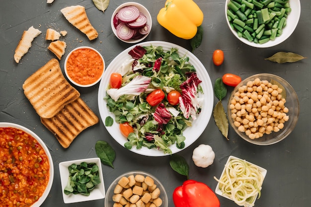 Top view of dishes with salad and toast