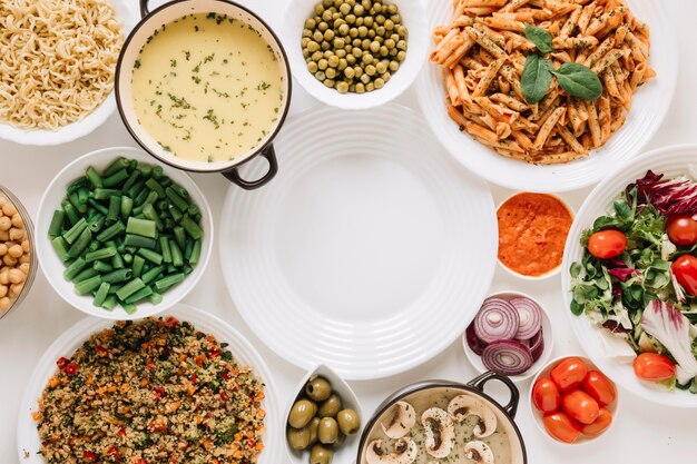 Top view of dishes with soup and cherry tomatoes