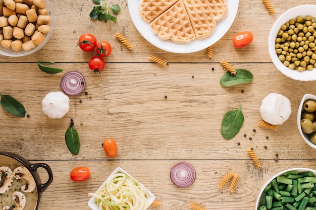 Top view of dishes with waffles and onions with copy space