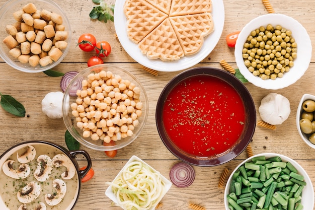 Top view of dishes with waffles and tomato soup