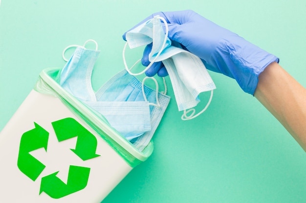 Top view disposable medical masks and hand with gloves