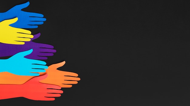 Top view diversity composition with different colored paper hands with copy space