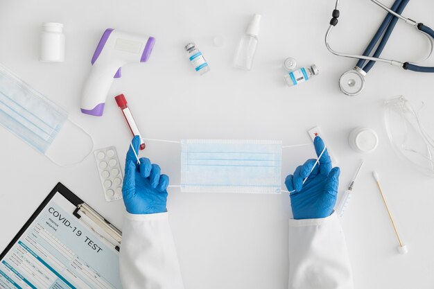 Top view doctor holding a face mask