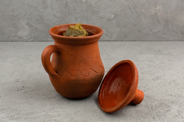 Top view dolma in pot green famous eastern meat meal inside brown pot on the grey