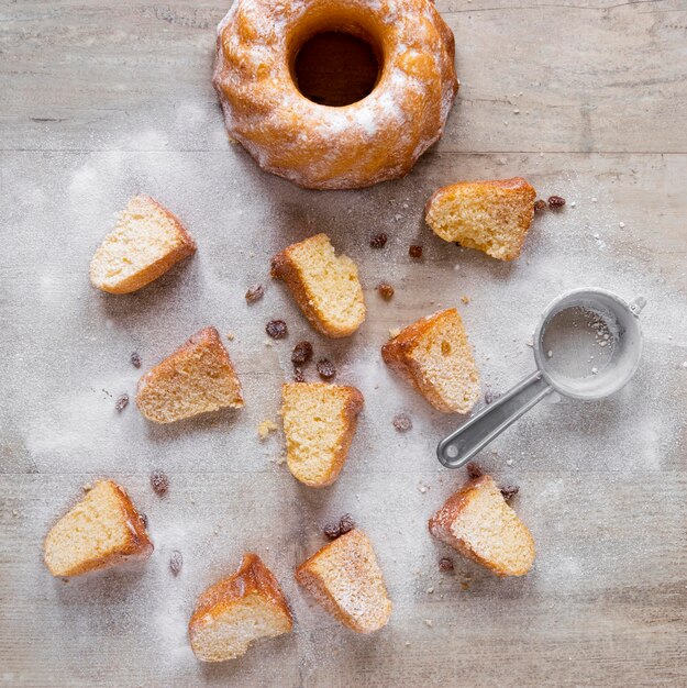 Top view of donut pieces with powdered sugar and raisins