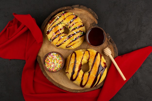 top view donuts sweet yummy delicious on the brown desk and dark background