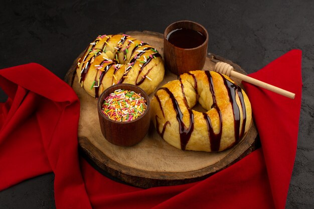 top view donuts sweet yummy delicious on the brown desk and dark background