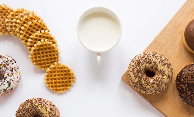 Top view of donuts and waffles with milk