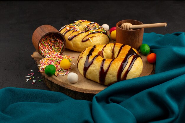 top view donuts with chocolate on the dark desk