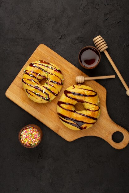 top view donuts with chocolate on the dark desk