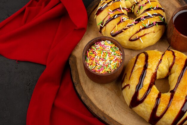 top view donuts yummy delicious sweet on the brown wooden desk and dark