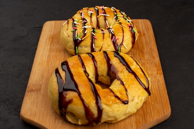 top view donuts yummy delicious sweet with chocolate on the brown desk and dark