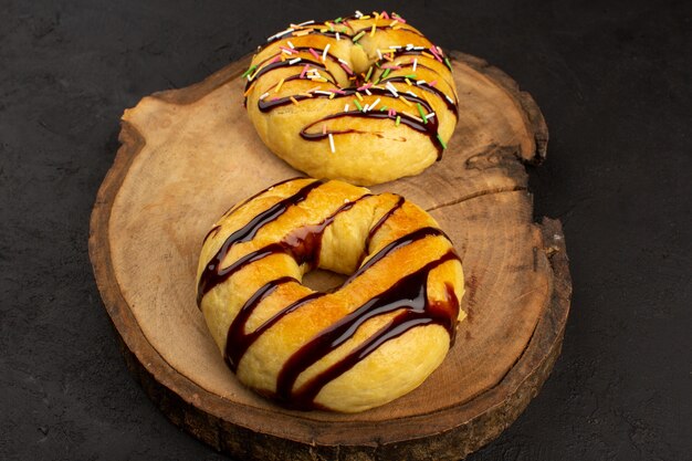 top view donuts yummy delicious with chocolate on the brown desk and grey background