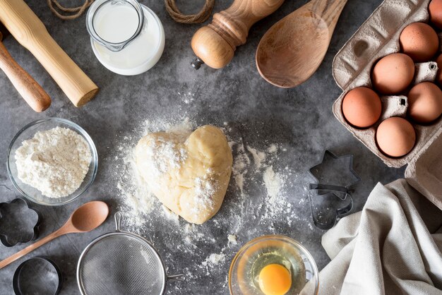 Top view dough on counter with flour and eggs