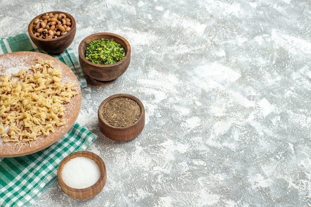 Top view dough and rolling-pin on dough board on tablecloth on grey background