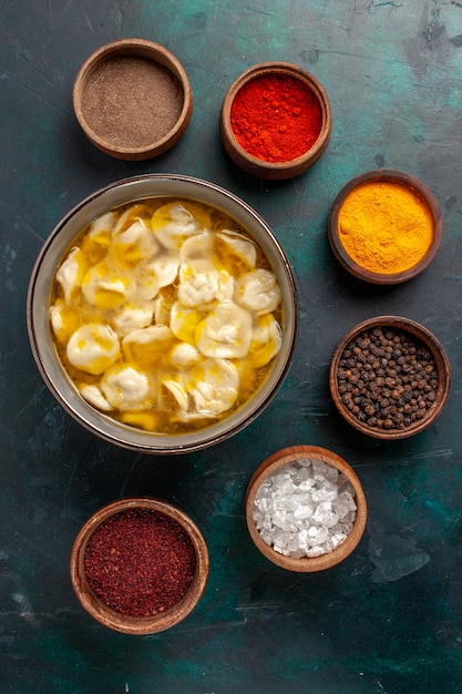 Top view dough soup with different seasonings on dark-blue surface ingredient soup food meal dough dinner sauce