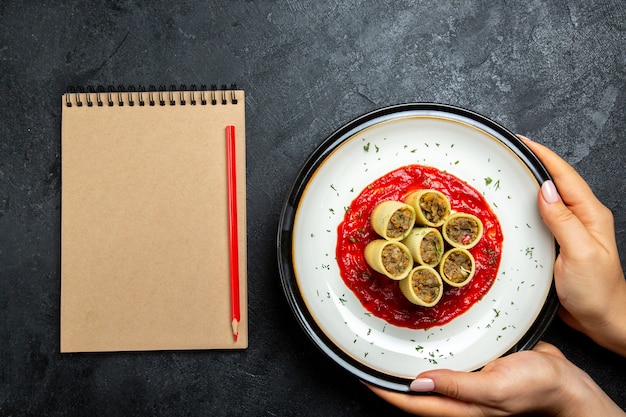 Top view dough with meat sliced slices with tomato sauce on grey desk