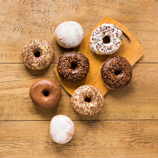 Top view of doughnuts on chopping board