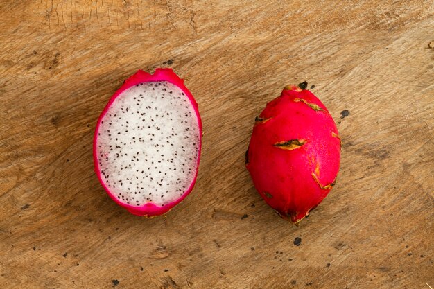 Top view dragon fruit with wooden background