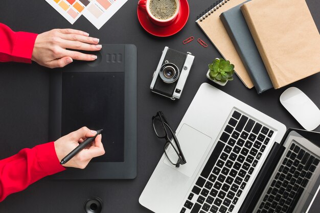 Top view of drawing pad on desk with laptop