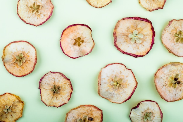 Top view of dried apple slices isolated on light blue background