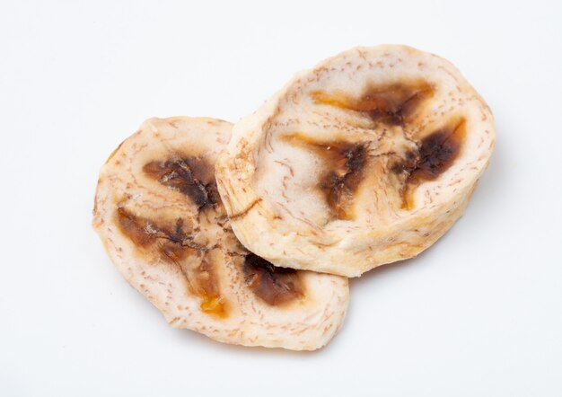 Top view of dried banana chips isolated on white background