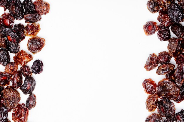 Top view of dried cherries on white background with copy space